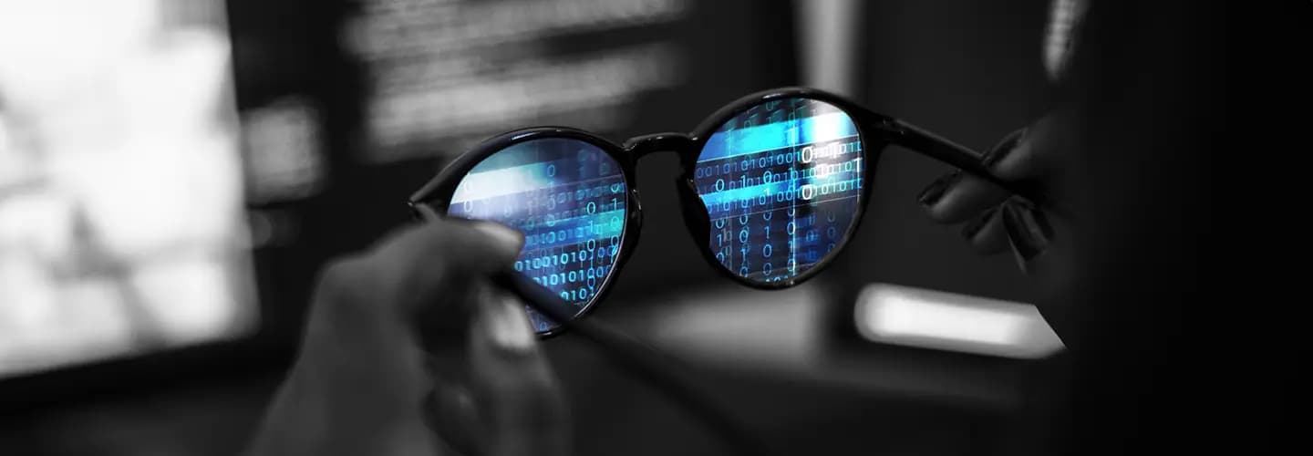 a guy checking his specs..and the specs has codes written on the glass