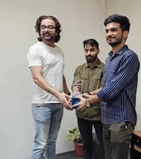 Founder of the company giving award to an employee